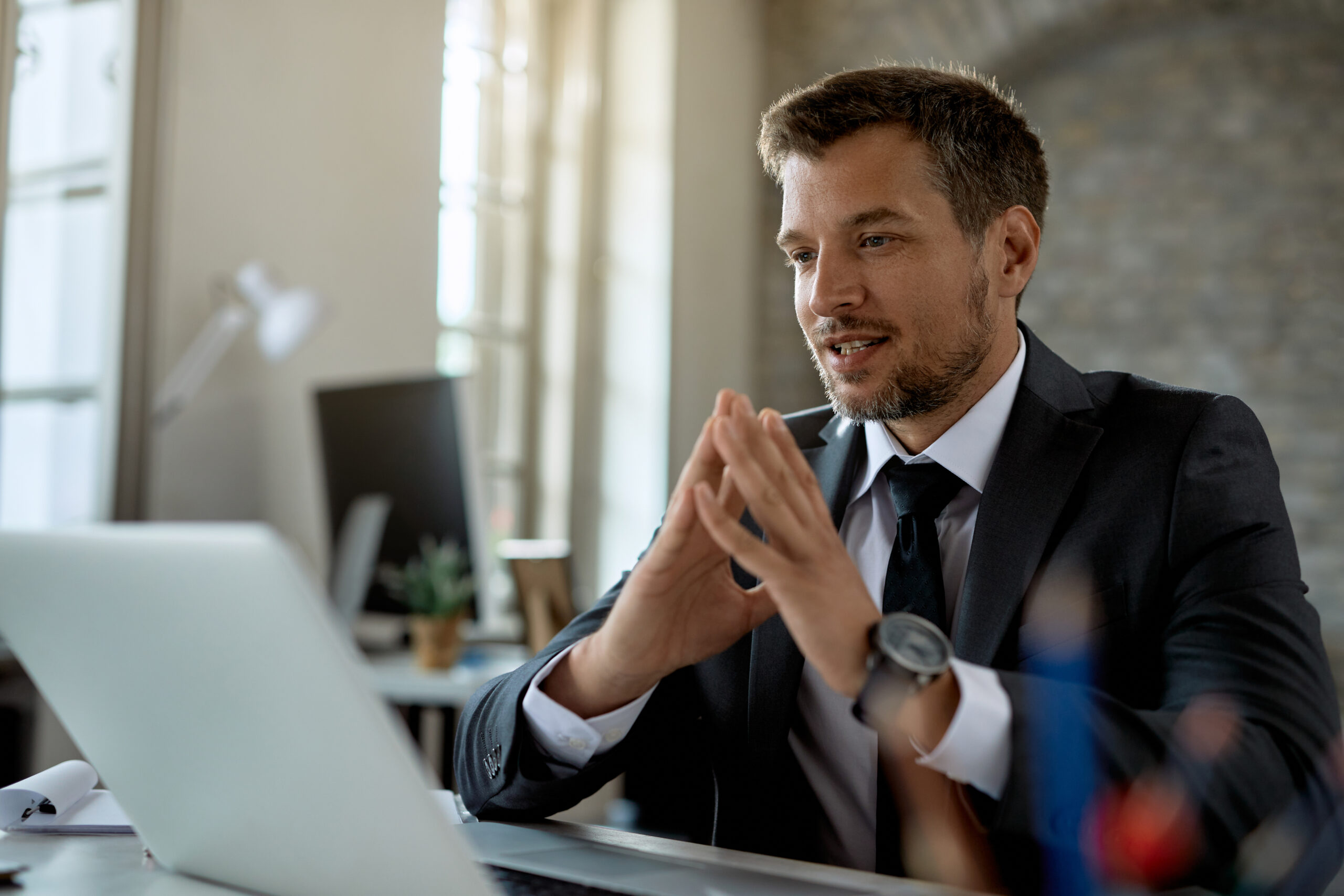 mid adult businessman using computer while working in the office